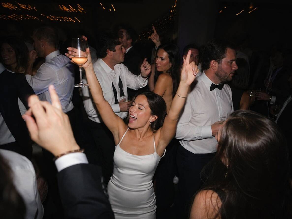 Couple smiling as they walk through their wedding celebration